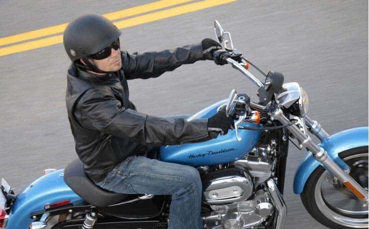 Motorcycle rider with half helmet