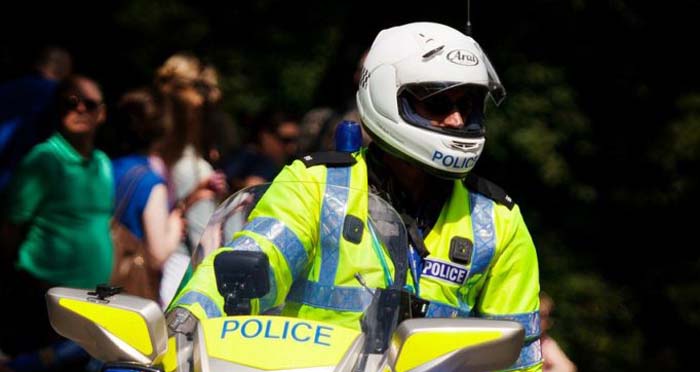 Policeman on bike with helmet on